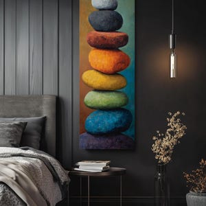 May include: A vertical canvas art piece depicting a stack of colorful stones. The stones are in shades of blue, green, yellow, orange, red, black, and gray. The artwork is displayed in a bedroom setting.