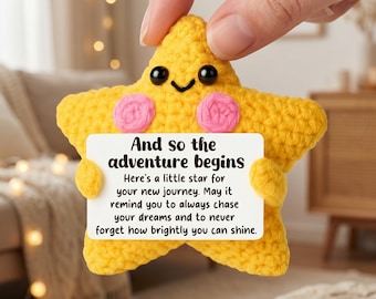 May include: A yellow crocheted star plush toy with black bead eyes and pink stitched cheeks. The star holds a white rectangular card with the text: And so the adventure begins. Here's a little star for your new journey. May it remind you to always chase your dreams and to never forget how brightly you can shine.