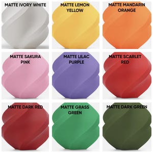 May include: A grid of nine spherical objects with a twisted, spiraled surface texture in matte finishes. Colors include ivory white, lemon yellow, mandarin orange, sakura pink, lilac purple, scarlet red, dark red, grass green, and dark green.