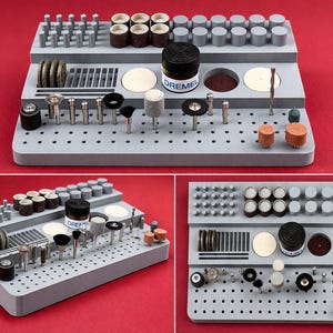 May include: A gray Dremel tool organizer with various rotary tool bits and accessories. The organizer has multiple levels and includes cylindrical grinding stones, sanding discs, and polishing wheels. A jar of Dremel accessories is visible.