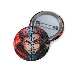May include: Two round buttons with a graphic of a split-faced anime character. One side is in a red hoodie with red accents, the other side is in black with a sinister expression. The buttons have a metal pin back.