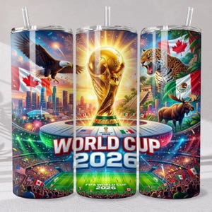 May include: A cylindrical tumbler with a straw featuring a graphic of the FIFA World Cup 2026 trophy, a stadium, a bald eagle, a jaguar, a moose, and the flags of Canada, the United States, and Mexico, with the text WORLD CUP 2026 displayed prominently.