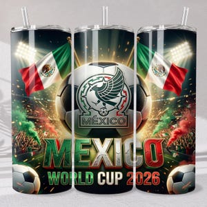 May include: A cylindrical tumbler with a straw featuring a soccer theme, the Mexican flag, a soccer ball with a stylized eagle emblem, and the text MEXICO WORLD CUP 2026. The design includes stadium lights, crowd scenes, and green and red smoke.