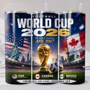 May include: A cylindrical tumbler featuring a Football World Cup 2026 design with the Statue of Liberty, the FIFA trophy, and the Angel of Independence. It displays the flags of the USA, Canada, and Mexico, with text reading World Cup 2026.