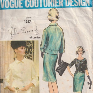 May include: Vintage Vogue Couturier Design sewing pattern number 1317 by John Cavanagh of London. The pattern features two women's dress designs. One is a teal blue dress with a matching jacket and the other is a teal blue skirt with a black and white patterned top.