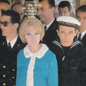 May include: Vintage magazine cover showing a woman in a turquoise knit dress with a white lace collar and tie. The cover text reads "The All-Girl Knits" and "Flirtatious, Fascinating and Wildly Feminine... In Patons Charm."