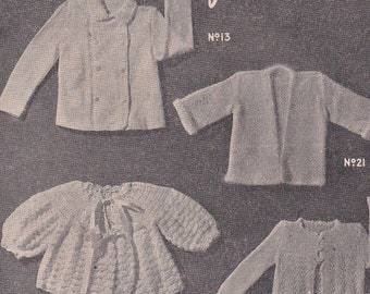May include: A vintage knitting pattern book for babies, featuring five different sweater designs. The book cover is pink and white with the title "Baby Book" and the words "American Styles" and "Book No. 2".