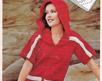 May include: A red crocheted hooded top with white trim and a zip down the front. The top is shown on a model against a rocky background. The text "EMPISAL SUMMER KNITWEAR" is at the top of the image. The text "BOOK AUP5" is in the top right corner of the image.