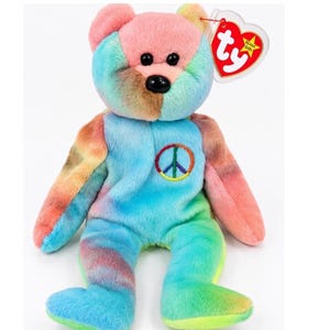 May include: A plush teddy bear with tie-dye fur in shades of pink, blue, yellow, and green. The bear features black plastic eyes and a black nose. An embroidered rainbow peace sign is on the chest. A heart-shaped Ty Beanie Babies tag is attached.