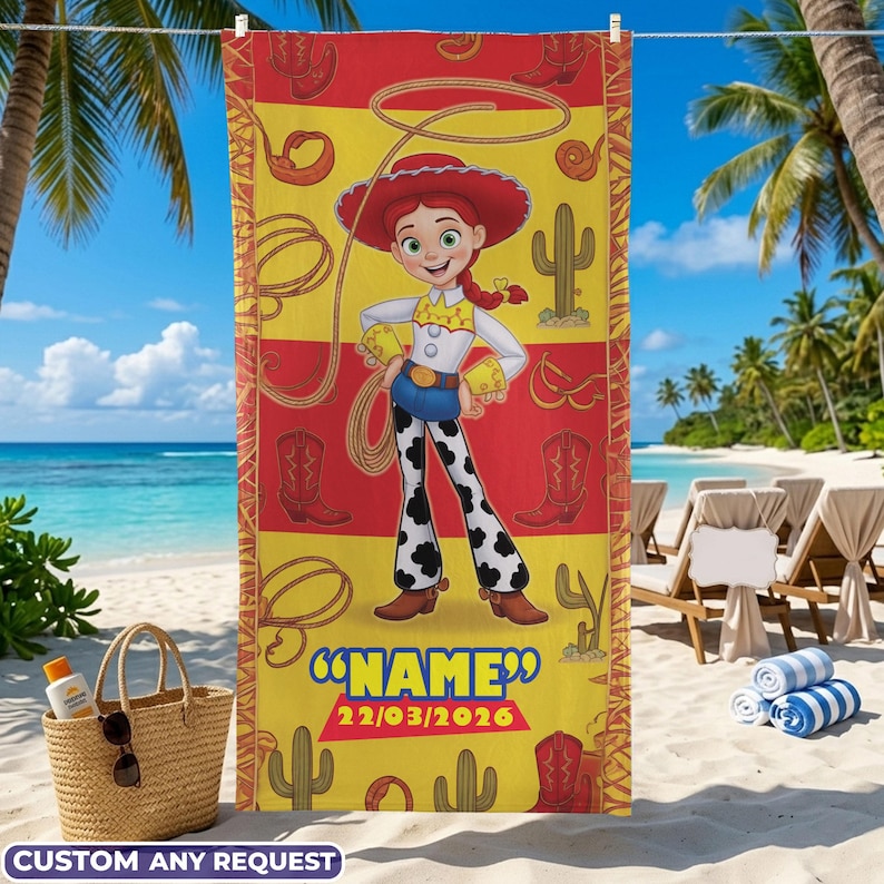 May include: A beach towel featuring a cartoon cowgirl character in a red hat and outfit, with a lasso and cowboy boots design. The towel has a yellow and red background with the text "NAME" and the date "22/03/2026".