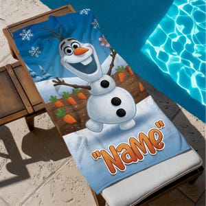 May include: A blue and white beach towel featuring the character Olaf from the movie Frozen. The towel has a cartoon illustration of Olaf in a snowy scene with carrots and the word "Name" in orange.