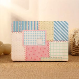 May include: A laptop hard shell case featuring a patchwork design with various patterns including blue stripes, yellow polka dots, pink polka dots, light blue gingham, and a green grid. The case has a cutout for the central Apple logo.