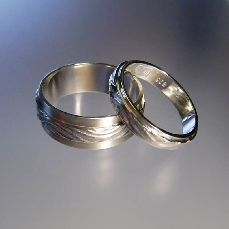 Water on sand wedding rings image 1