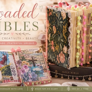 May include: A decorated Holy Bible featuring a dark green cover with a floral pattern, white lace trim, and neon pom-pom page markers. The open pages display colourful religious collages, floral illustrations, and text including I am with you always.