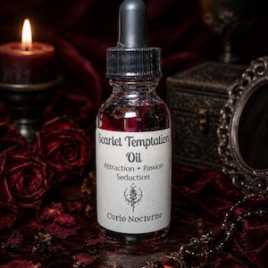 May include: A glass bottle of "Scarlet Temptation Oil" with a black dropper, set against a dark red backdrop. The label lists "Attraction, Passion, Seduction" and "Curio Nocturne." A lit candle, roses, and a pendant necklace are also visible.