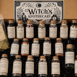 May include: A Witch's Apothecary kit in a cardboard box containing a plastic bag of bay leaves and seventeen glass jars with cork stoppers. Each jar features a white label with text identifying contents like crystals, rose petals, and moon water.