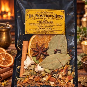 May include: A clear plastic pouch containing The Prosperous Home simmer pot blend. The label lists ingredients including orange slices, cinnamon sticks, ginger root, cardamom, cloves, chamomile, calendula, star anise, spearmint, and bay leaves.