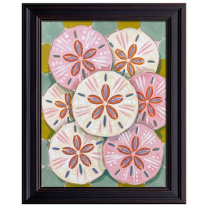 May include: Framed artwork featuring a cluster of stylized sand dollars in shades of pink and cream, with orange and blue accents. The sand dollars are arranged against a light green and yellow background, all within a dark brown frame.
