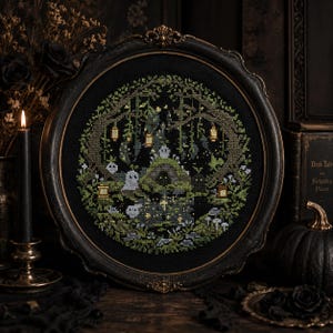 May include: A framed cross-stitch artwork featuring a spooky forest scene with ghosts, lanterns, and a moss-covered structure. The artwork is in a round, ornate black frame. The color palette includes greens, grays, and blacks, creating a gothic aesthetic.