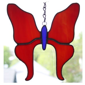 stained glass suncatcher of an orange-red butterfly