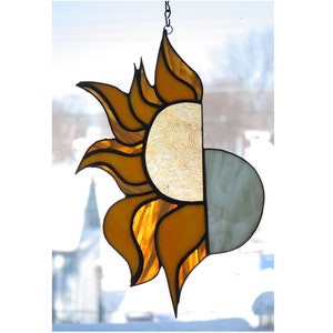 stained glass suncatcher of the sun and moon