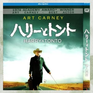 May include: Blu-ray disc of the film "Harry & Tonto" featuring Art Carney. The cover has a green and tan color scheme with Japanese text and the English title. The image shows a man in a coat and hat walking on a road.