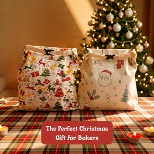 May include: Two off-white fabric roll-top bags with black plastic buckles. The left bag features a pattern of red reindeer, green trees, and gifts. The right bag displays a Santa Claus face, stockings, and trees. Both bags have a roll-top closure.