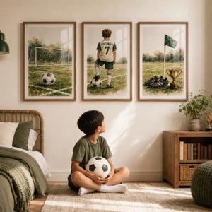 May include: Three framed wall art prints featuring football themes. The left print shows a football goal and ball. The centre print depicts a child in a jersey with the name BRENNAN and number 7 standing on a ball. The right print shows a flag, boots, and a trophy.