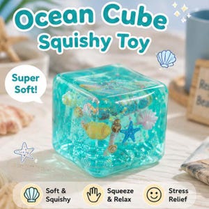 May include: A translucent turquoise cube squishy toy containing embedded miniature seashells and a blue starfish. The toy features text that reads Ocean Cube Squishy Toy, Super Soft, Soft & Squishy, Squeeze & Relax, and Stress Relief.