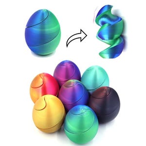 May include: A collection of colorful, egg-shaped fidget toys. One is shown in its closed form and transformed into an open, spiral shape. The toys are in shades of blue, green, purple, red, and gold. The toys are designed to be opened and closed.