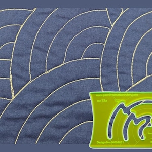 May include: A dark blue fabric featuring a yellow stitched Baptist Fan quilting pattern. A lime green acrylic quilting ruler is positioned in the bottom right corner, displaying the text www.parrsfreemotionrulers.com, No:13a, Design No:60005831, and Baptist Fan.