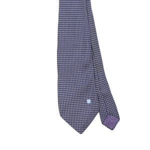 May include: A dark navy blue necktie featuring a repeating pattern of small white dots. The tie has a pointed end and includes a small, square light blue logo patch near the bottom corner with the white text Pierre Cardin printed on it.