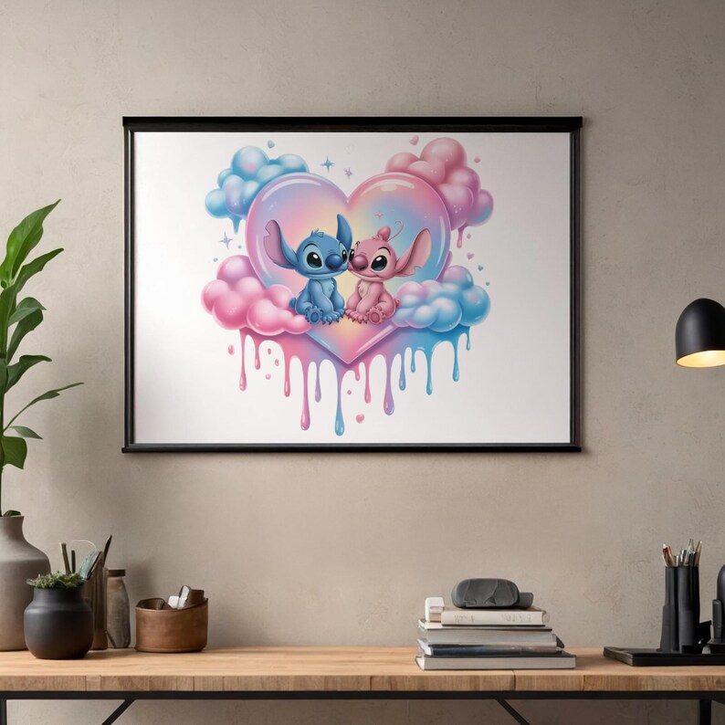 May include: A framed wall art print featuring a blue alien character and a pink alien character sitting together inside a large, pastel-colored heart shape surrounded by fluffy pink and blue clouds with paint-like drips extending downward.