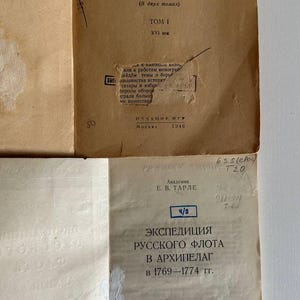 K&ouml;nnte beinhalten: Zwei alte Buchumschl&auml;ge aus Papier in Beige und Off-White mit schwarzem kyrillischem Text. Der obere Umschlag tr&auml;gt den Titel "Россия и Турция" und das Datum 1946. Der untere Umschlag zeigt den Titel "Экспедиция русского флота в архипелаг" und das Jahr 1945.