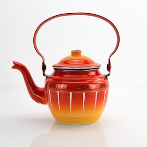 May include: A metal teapot featuring a vibrant gradient finish that transitions from deep red at the top to bright yellow at the base. The body is decorated with vertical white stripes and a gold-toned band, complete with a matching lid and handle.