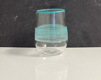 Stemless glass with teal and white swirl and teal rim