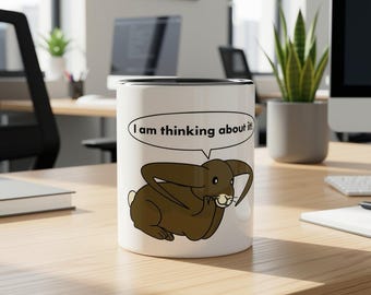 This black ceramic mug with a lop-eared rabbit is a cheerful addition for coffee and tea lovers! A nice gift for colleagues!