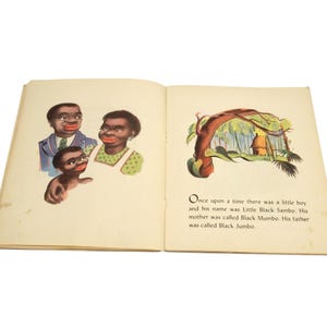 May include: Open book with illustrations and text. The left page shows three figures with dark skin and red lips. The right page has a colorful illustration of a hut and text that reads "Once upon a time there was a little boy and his name was Little Black Sambo."
