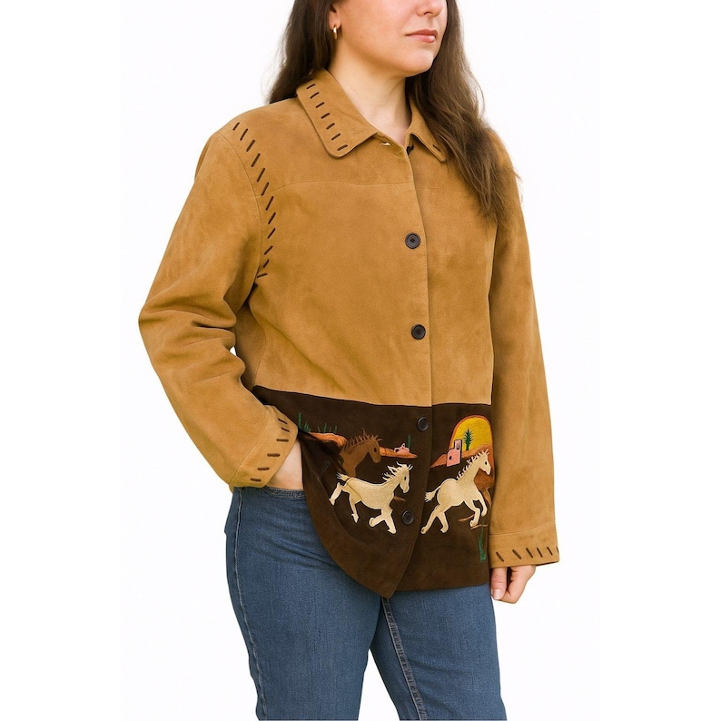Woman wearing a vintage 1990s Quacker Factory tan and brown suede jacket with embroidered running horses, cacti, and sunset desert scene.