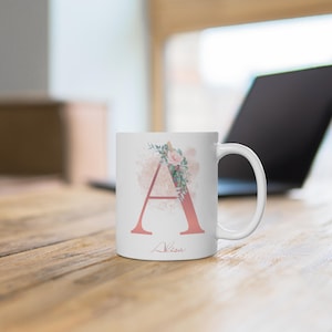 May include: A set of three ceramic mugs with a speckled, matte finish. The mugs are in shades of cream, light gray, and dark gray. Each mug has a simple, minimalist design, perfect for coffee or tea.
