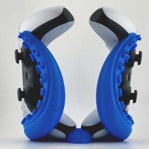 May include: A blue octopus-shaped controller stand holding two white and black game controllers. The stand features eight curved tentacles with circular suction cup details, providing a secure base for the controllers to rest upright.