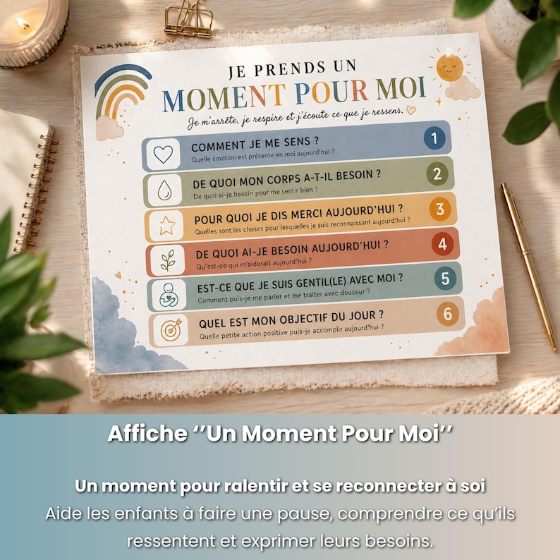 May include: A printed poster titled "Un Moment Pour Moi" in French, featuring a rainbow, clouds, and a list of questions. The poster is designed to help children reflect on their feelings and needs. A gold pen and paperclip are visible.