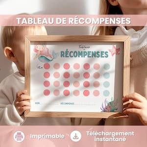 May include: A framed reward chart with the text "TABLEAU DE RÉCOMPENSES" at the top. The chart features pink and blue circles for tracking progress, with mermaid illustrations. The bottom of the chart includes the words "Imprimable" and "Téléchargement instantané".