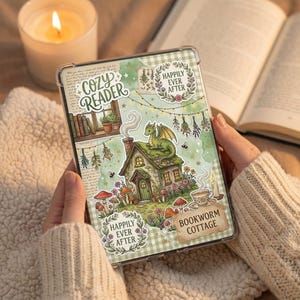 May include: A tablet case with a fantasy cottage design, complete with a dragon, mushrooms, and flowers. The case has the text "Cozy Reader" and "Bookworm Cottage". A lit candle and an open book are visible in the background.