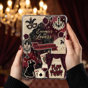 May include: A clear tablet case featuring a dark romance theme. The design includes a masquerade mask, roses, a chandelier, and the text "Enemies to Lovers" and "Dark Romance Reader". Other elements include playing cards, a wine glass, and the words "Plot Twist".