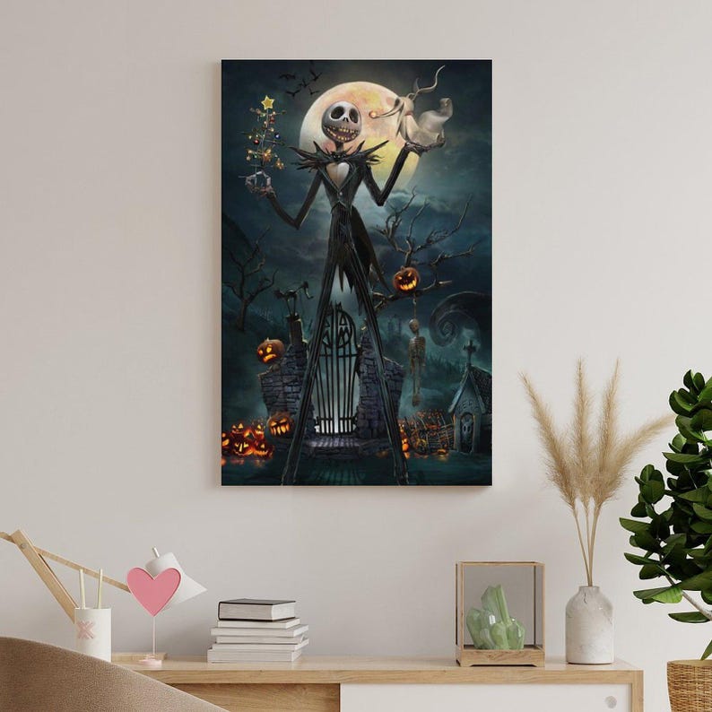 May include: A framed canvas print featuring Jack Skellington from The Nightmare Before Christmas. The artwork depicts Jack in a black suit, holding a Christmas tree and Zero, with a full moon and Halloween town in the background. Pumpkins and a spooky gate are also visible.