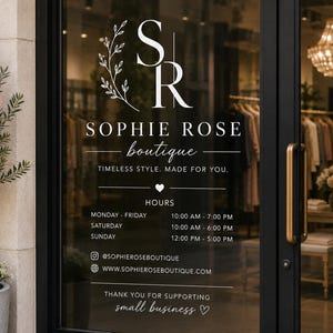 May include: A white vinyl decal applied to a glass door featuring the logo SR with a leaf branch, the text SOPHIE ROSE boutique, the slogan TIMELESS STYLE. MADE FOR YOU., business hours, social media handle, website, and the text THANK YOU FOR SUPPORTING small business.