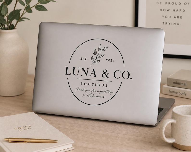 Business window vinyl decal with custom logo and hours displayed on laptop for small business branding