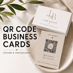 May include: A stack of white business cards with the text LB LASH BEAUTY LASH EXTENSIONS & BROW STYLING and a single card featuring a QR code, the text LET'S CONNECT, @LASHBEAUTY, 123-456-7890, and THANK YOU FOR SUPPORTING MY BUSINESS.