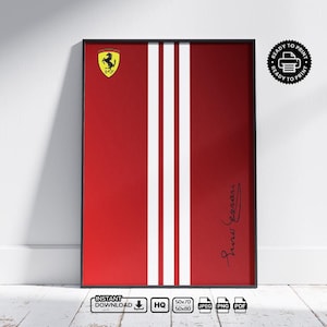 Pode incluir: Obra de arte vermelha emoldurada com duas listras verticais brancas, um logotipo da Ferrari e uma assinatura impressa. A obra de arte é exibida em uma parede branca e piso de madeira. A moldura é preta.